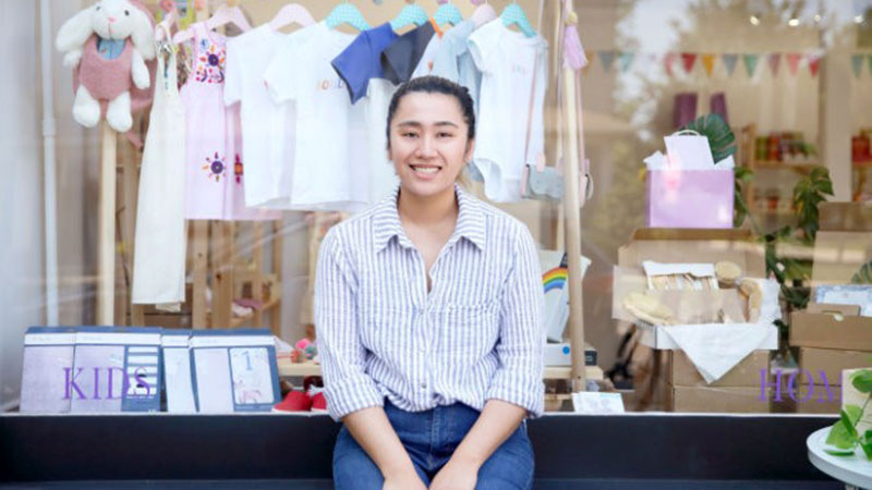 Asian woman in front of kids store