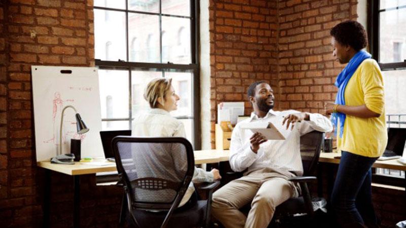 Three employees talking